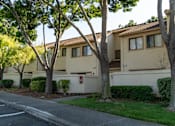 Thumbnail 5 of 22 - the exterior of a building with trees in front of it at Cowell Terrace Apartments, Concord