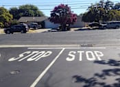 Thumbnail 12 of 22 - an empty street with a stop sign on it at Cowell Terrace Apartments, California