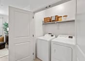 Thumbnail 39 of 40 - A white laundry room with a washer and dryer.