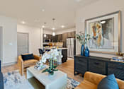 Thumbnail 11 of 19 - A modern living room with a large painting on the wall.