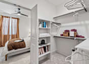 Thumbnail 38 of 40 - A bedroom with a bed, a desk, and a fan.