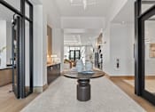 Thumbnail 12 of 40 - A modern living room with a wooden floor and a large coffee table in the center.