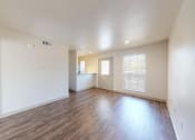 Thumbnail 7 of 60 - the living room and dining room of an empty house with wood flooring