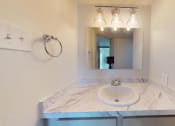 Thumbnail 19 of 60 - Bathroom sink with white countertop and mirror with lights