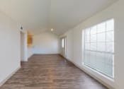 Thumbnail 21 of 60 - a spacious living room with a large window