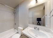 Thumbnail 29 of 60 - a white bathroom with a sink and a mirror
