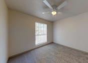 Thumbnail 24 of 60 - a bedroom with carpet, a ceiling fan and closet