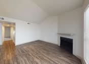 Thumbnail 27 of 60 - a living room with vinyl hardwood floors, fireplace and breakfast bar
