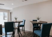 Thumbnail 43 of 60 - a dining room with three tables and blue chairs