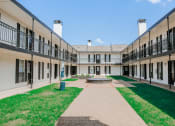 Thumbnail 38 of 60 - the courtyard of a building with grass and a fountain