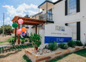 Thumbnail 46 of 60 - a building with a sign and balloons in front of it