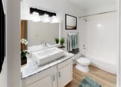 Thumbnail 11 of 23 - a bathroom with a sink and a toilet and a shower