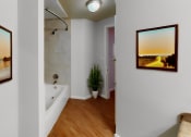 Thumbnail 8 of 22 - a bathroom with a tub and pictures on the wall