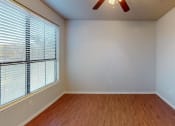 Thumbnail 11 of 22 - an empty living room with a large window and wood floors