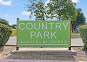 Thumbnail 4 of 23 - A green sign that says "Country Park Apartment Homes".