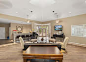 Thumbnail 16 of 38 - A spacious living room with a wooden dining table and chairs.
