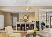 Thumbnail 15 of 38 - A modern kitchen with a dining table and chairs.