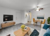 Thumbnail 1 of 16 - a living room with a couch and a coffee table and a tv