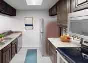 Thumbnail 3 of 22 - a kitchen with stainless steel appliances and a counter top with a bowl of fruit