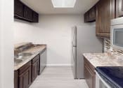 Thumbnail 14 of 22 - a kitchen with a stove microwave and refrigerator
