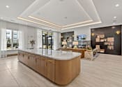 Thumbnail 13 of 40 - A reception area with a large counter and a TV mounted on the wall.