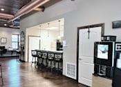 Thumbnail 20 of 26 - a bar area with a bar stool and a coffee machine