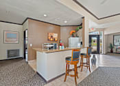 Thumbnail 10 of 23 - A room with a bar and chairs.