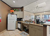 Thumbnail 9 of 23 - A kitchen with a white fridge and a white dishwasher.