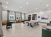 Thumbnail 17 of 19 - A spacious room with a table and chairs.