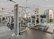 Thumbnail 24 of 27 - A gym with treadmills and elliptical machines.