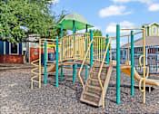 Thumbnail 8 of 23 - A playground with a yellow slide and a green canopy.