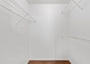 Thumbnail 32 of 38 - Empty white room with shelves and a wooden floor.