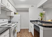 Thumbnail 36 of 38 - A kitchen with white appliances and cabinets.