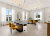 Thumbnail 19 of 40 - A modern dining room with a large table and yellow chairs.