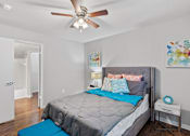 Thumbnail 29 of 38 - A bedroom with a bed, pillows, and a ceiling fan.