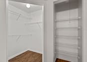 Thumbnail 27 of 38 - A walk in closet with shelves and hangers.