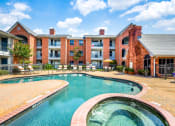 Thumbnail 18 of 20 - a swimming pool with an apartment building in the background