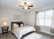 Thumbnail 14 of 18 - a bedroom with a bed and a ceiling fan