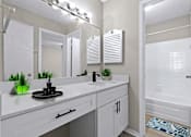 Thumbnail 4 of 16 - a bathroom with a large mirror and a sink and a shower