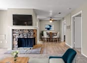 Thumbnail 1 of 16 - living room with fireplace and dining room with table and chairs
