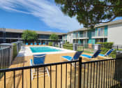 Thumbnail 15 of 18 - our apartments have a pool and a deck with chairs