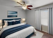 Thumbnail 8 of 18 - a bedroom with a large bed and a ceiling fan