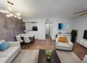 Thumbnail 2 of 18 - a living room and dining room with couches and a table