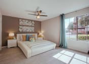 Thumbnail 6 of 20 - a bedroom with a bed and a ceiling fan