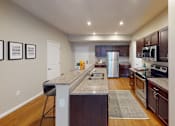 Thumbnail 3 of 26 - a kitchen with granite countertops and stainless steel appliances