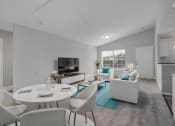 Thumbnail 1 of 13 - a living room with white furniture and a blue rug