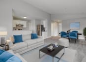 Thumbnail 5 of 13 - a living room with blue and white furniture and a kitchen