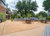 Thumbnail 24 of 37 - a patio with tables and chairs and a pool