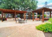 Thumbnail 33 of 37 - a patio with tables and chairs in front of a building