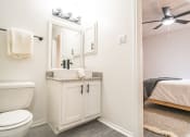 Thumbnail 14 of 37 - a bathroom with a toilet and a sink and a mirror